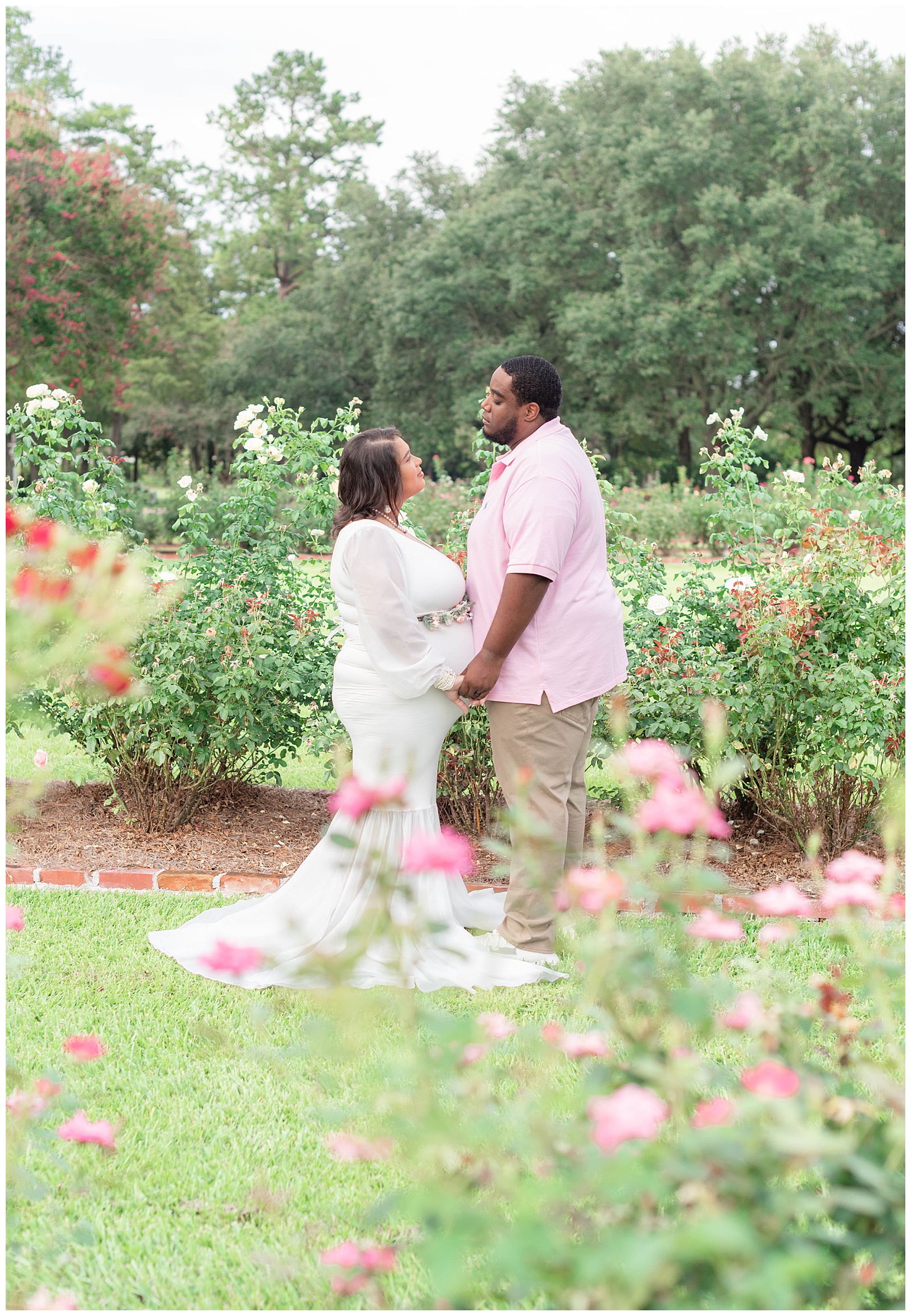 husband and wife share a loving moment in the rose garden at Burden Center