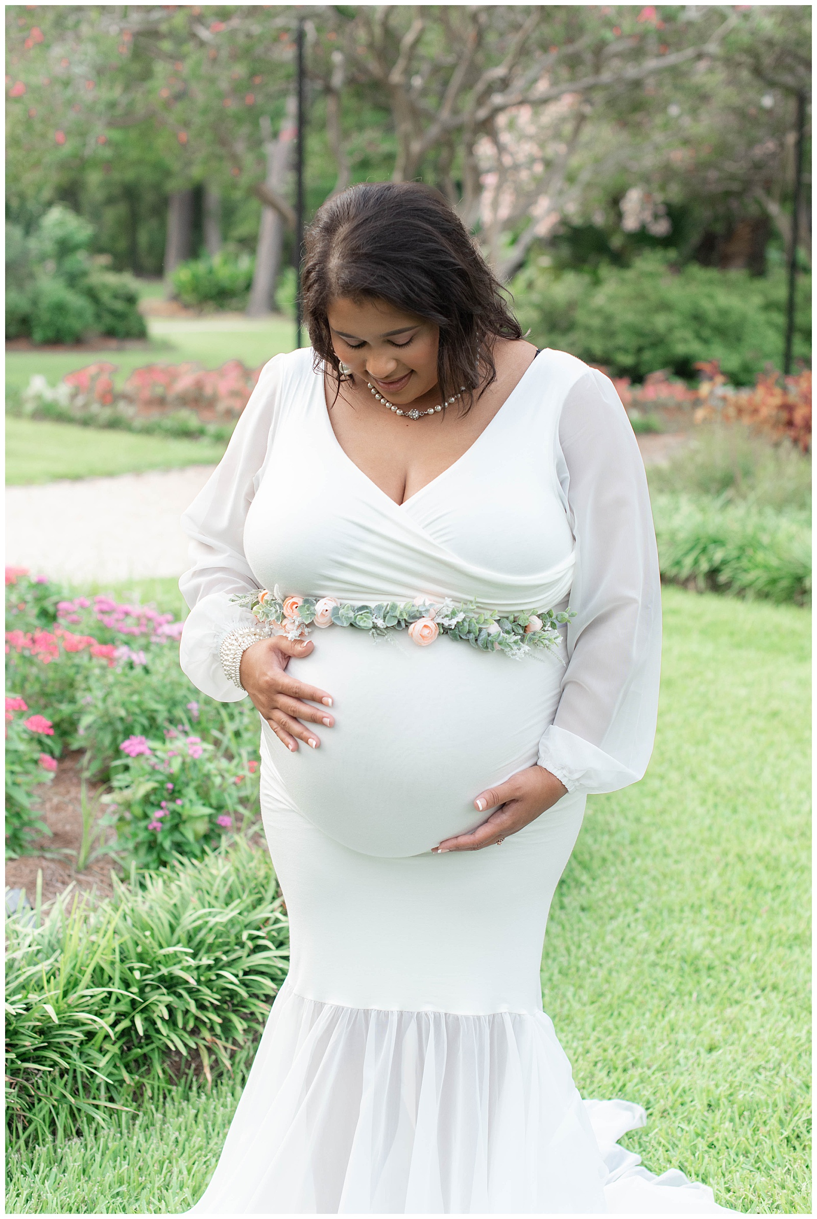 mom rubs baby belly in the rose garden at Burden Center