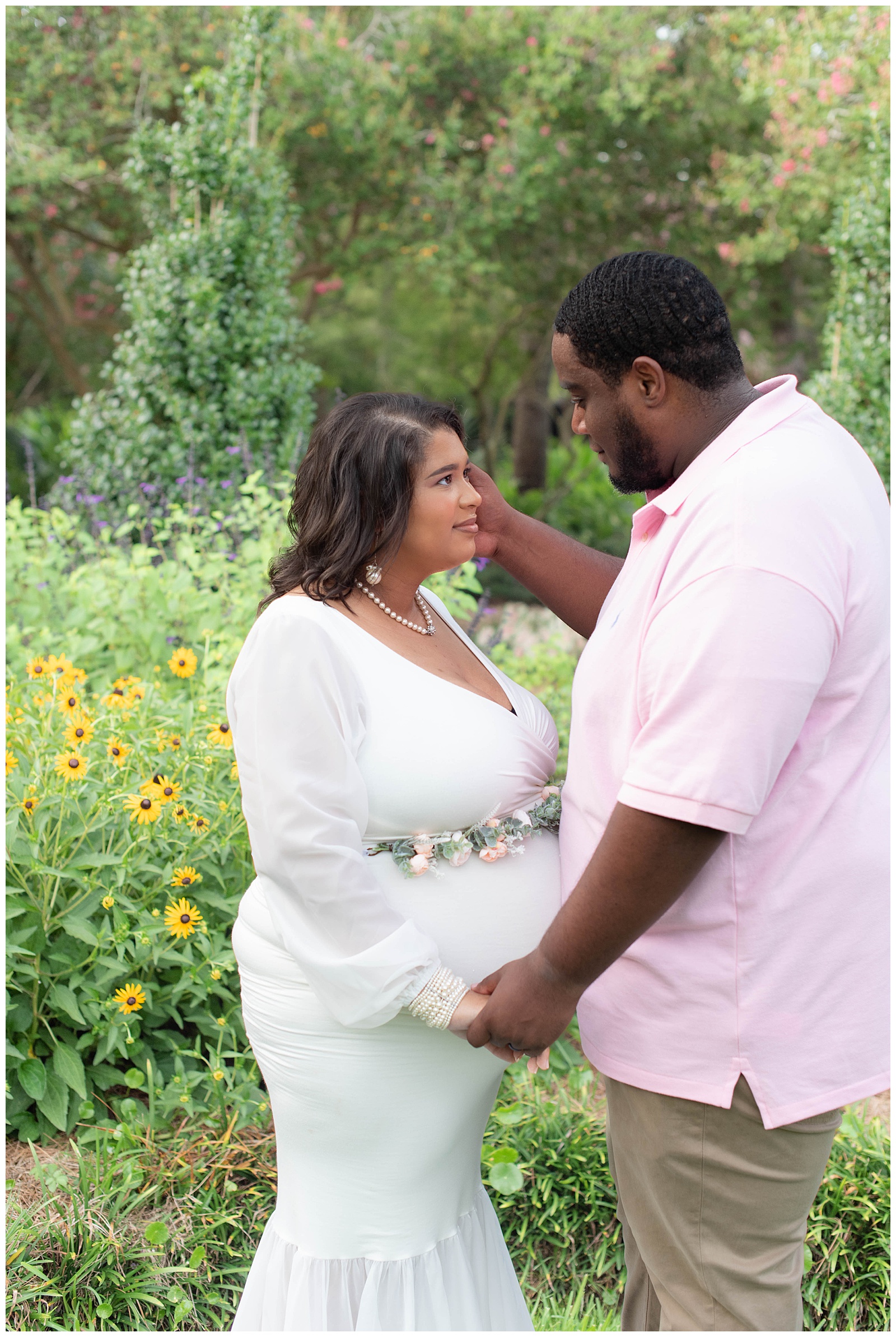 husband looks at wife in gardens at the Orangerie at Burden Center