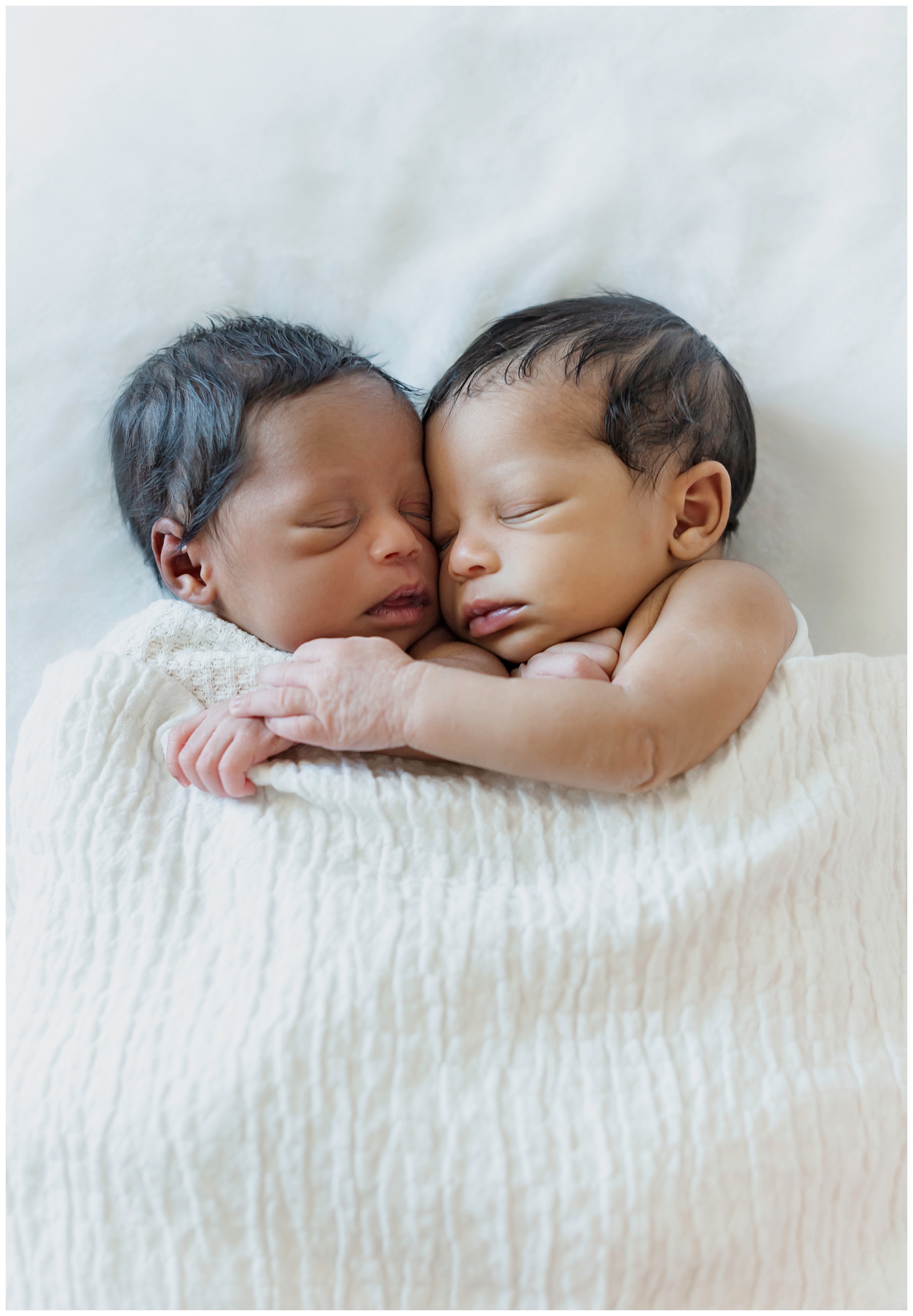 newborn twin girls wrap arms