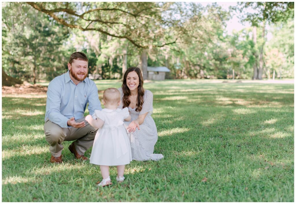 Baton Rouge Newborn Photographer -little girl runs to mom and dad in the grass