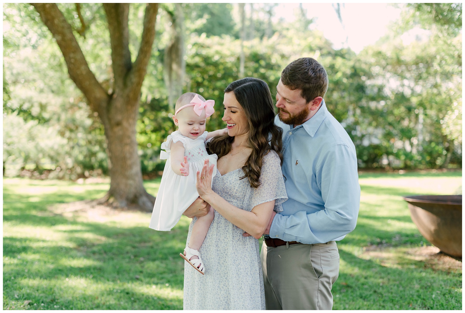 Baton Rouge Newborn Photographer - mom and dad clap hands with baby girl.