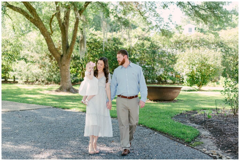 Baton Rouge Newborn Photographer - family walks together holding baby girl